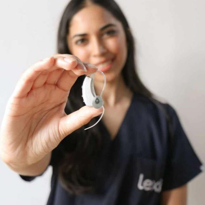 Audiologist holding lexie hearing aid