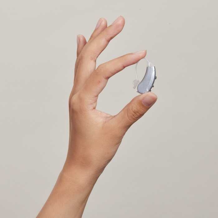 Image of Lexie hearing aids in hand