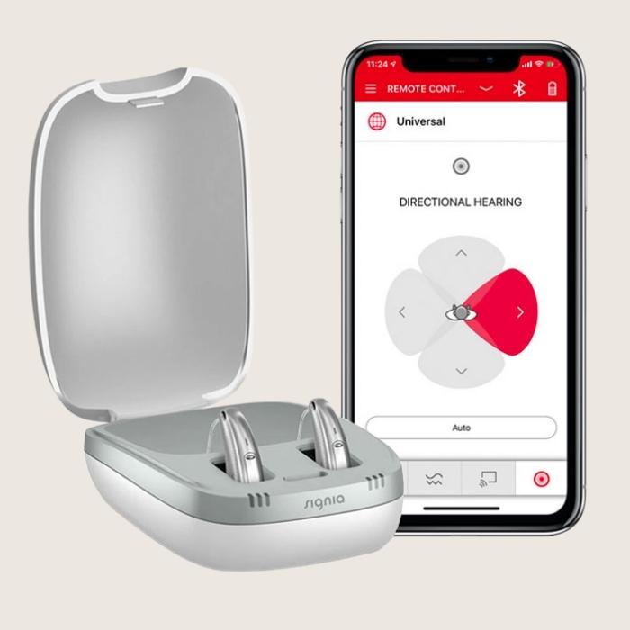 AX hearing aids in charge case with open Signia app