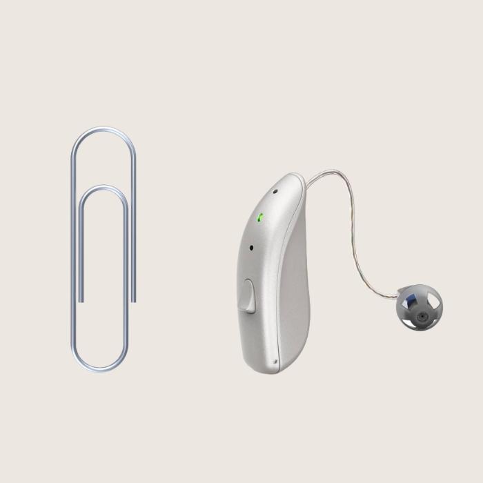 Image of Lively hearing aid next to a paperclip for size comparison