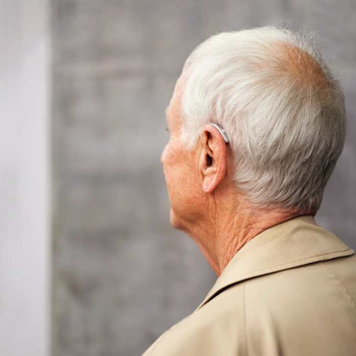 Older Man Wearing A Hearing Aid